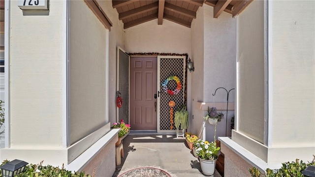 view of exterior entry with stucco siding