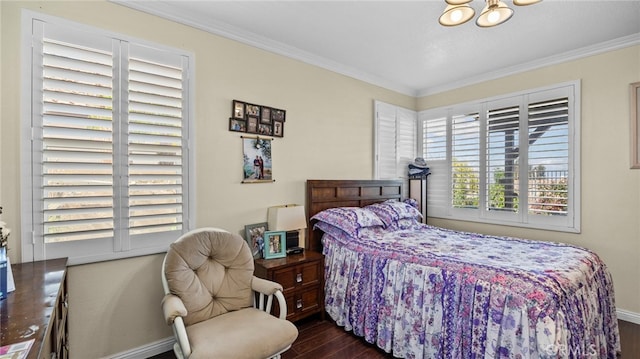 bedroom with dark wood finished floors, a notable chandelier, crown molding, and baseboards