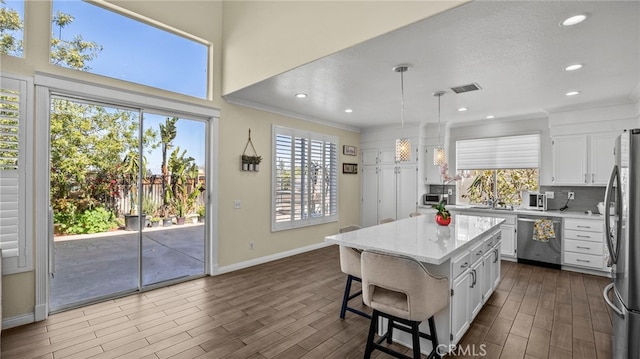 kitchen with visible vents, appliances with stainless steel finishes, white cabinets, and dark wood finished floors