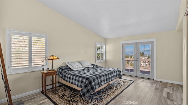 bedroom featuring access to exterior, french doors, vaulted ceiling, wood finished floors, and baseboards