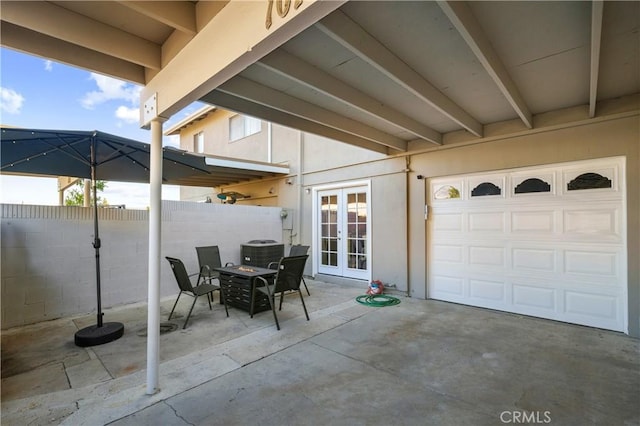 view of patio / terrace featuring outdoor dining space, french doors, central AC, and fence