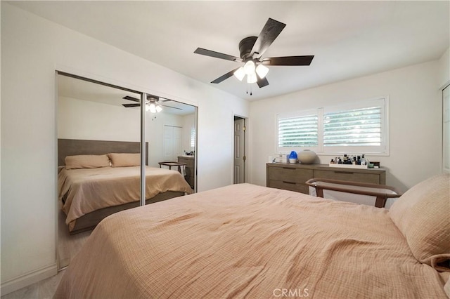 bedroom featuring a closet, baseboards, and a ceiling fan