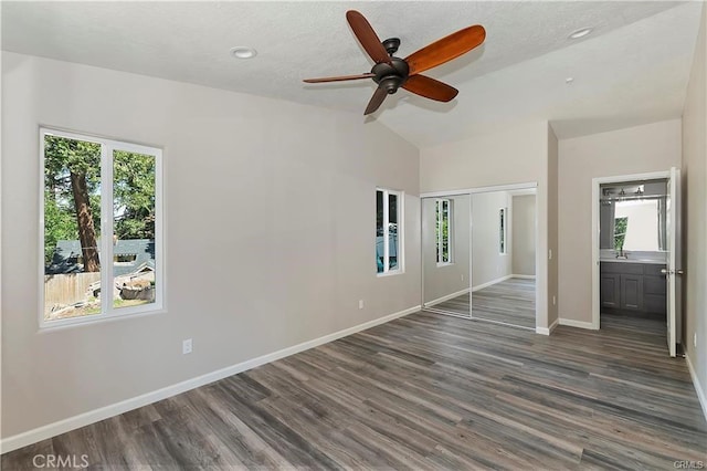 23511 Lake Dr, Crestline, CA 92325 - unfurnished bedroom with multiple windows, lofted ceiling, dark wood finished floors, baseboards, and a closet