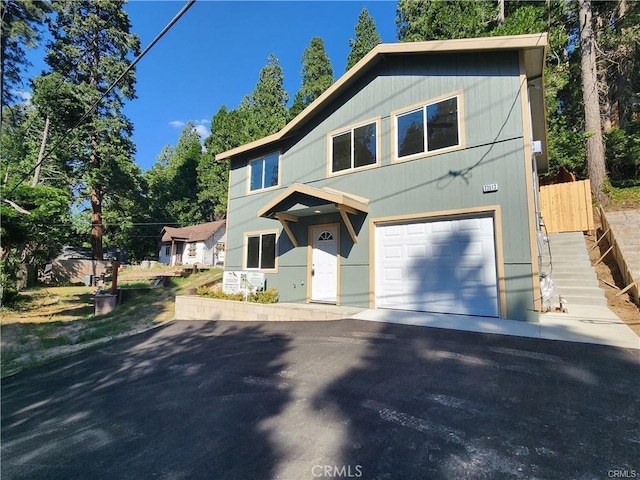 23511 Lake Dr, Crestline, CA 92325 - view of front facade featuring a garage and driveway