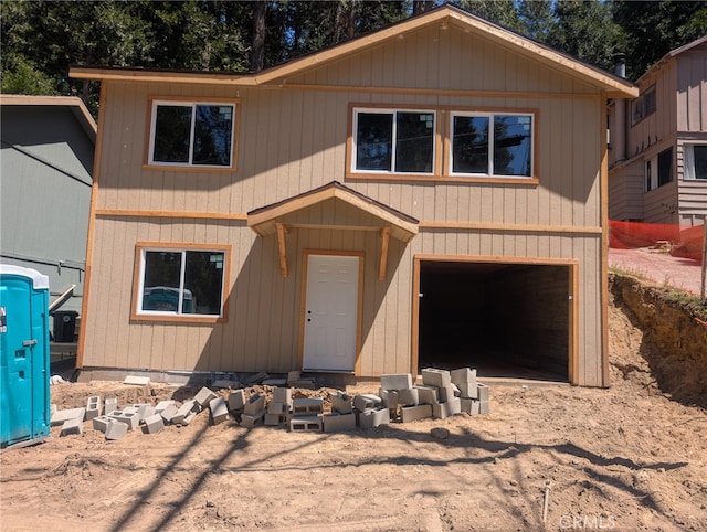 23511 Lake Dr, Crestline, CA 92325 - view of front of house featuring a garage and dirt driveway