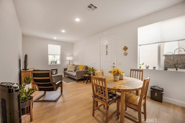 dining space with light wood-style floors, baseboards, visible vents, and recessed lighting