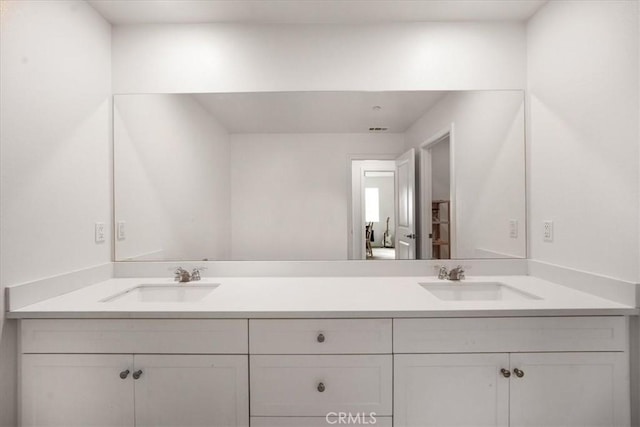 full bath with double vanity and a sink