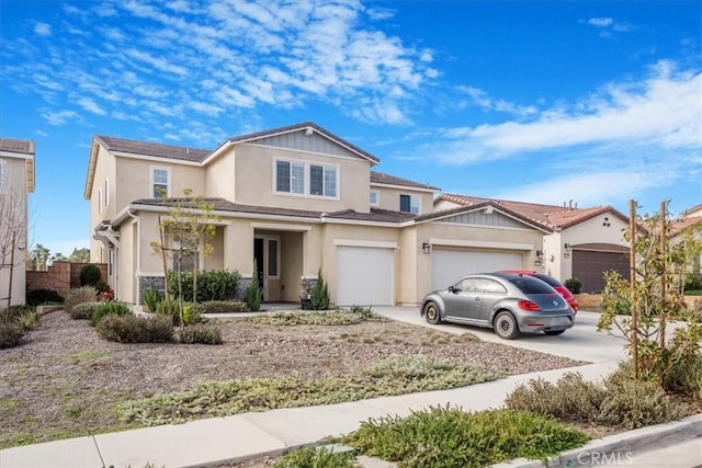 view of front of house with an attached garage, concrete driveway, and stucco siding