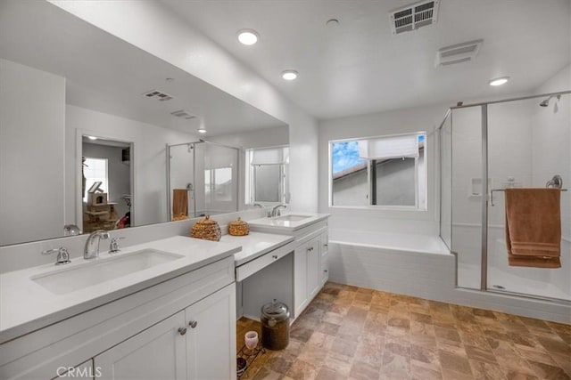 bathroom with a wealth of natural light, a stall shower, and visible vents