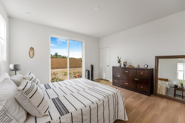 bedroom with access to outside and light wood-style floors