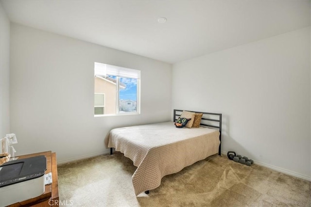 carpeted bedroom featuring baseboards