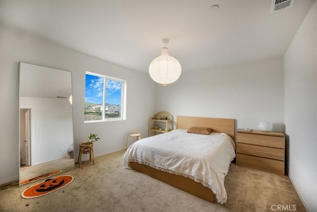 carpeted bedroom featuring visible vents and baseboards