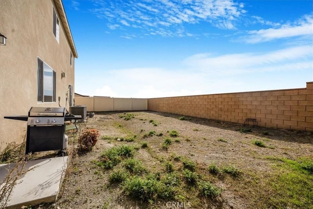 view of yard featuring a fenced backyard and central AC unit