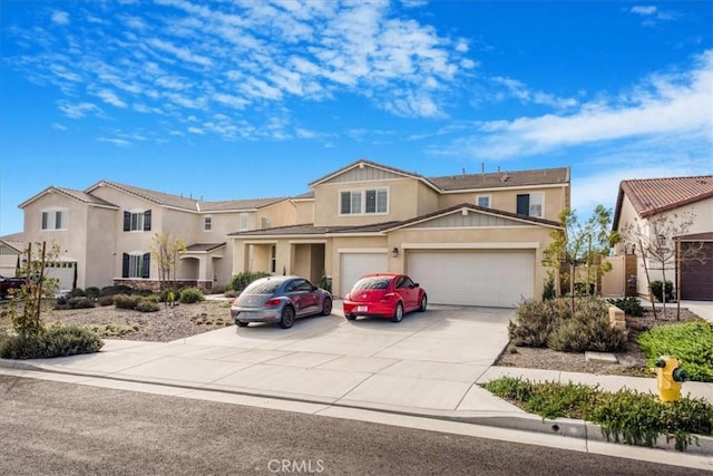 traditional-style home featuring driveway and stucco siding