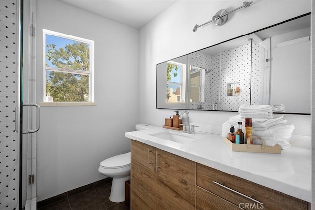 full bathroom with a stall shower, vanity, toilet, and tile patterned floors