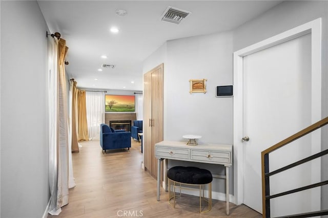 hall featuring recessed lighting, visible vents, and light wood-style floors