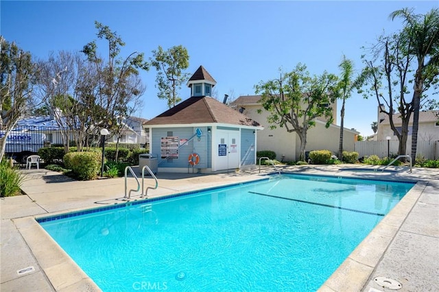 pool featuring fence and a patio