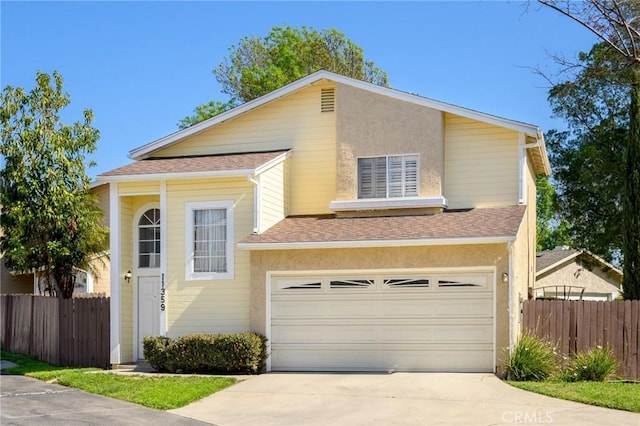 view of front of property with concrete driveway, roof with shingles, an attached garage, and fence