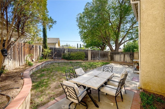 view of patio with outdoor dining area and a fenced backyard