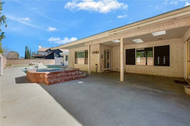 view of patio / terrace featuring a fenced backyard and an in ground hot tub