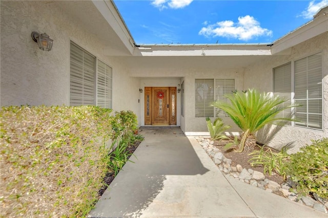 doorway to property with stucco siding