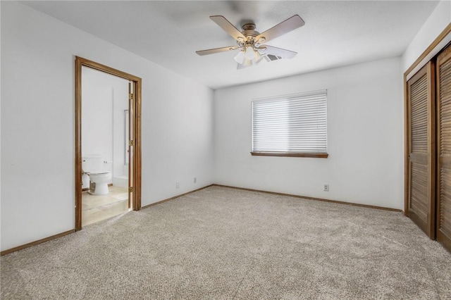 unfurnished bedroom featuring baseboards, a ceiling fan, connected bathroom, carpet flooring, and a closet