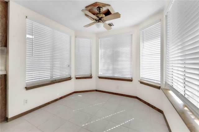 unfurnished sunroom with ceiling fan and a healthy amount of sunlight