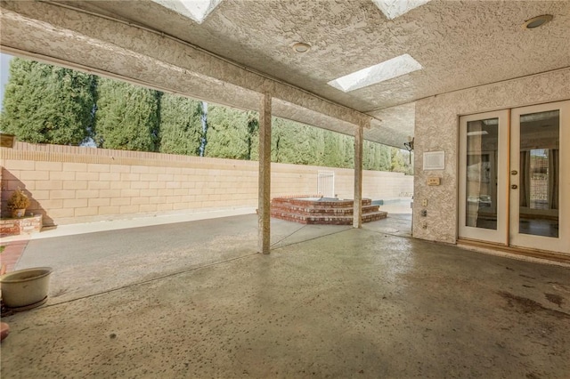 view of patio with french doors and a fenced backyard