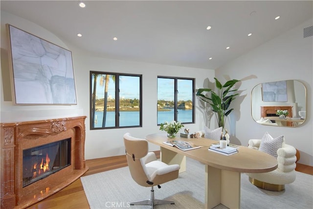 dining room with visible vents, a high end fireplace, wood finished floors, and recessed lighting