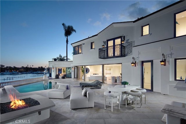 outdoor pool featuring a water view and a patio area