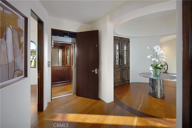 corridor featuring wood finished floors