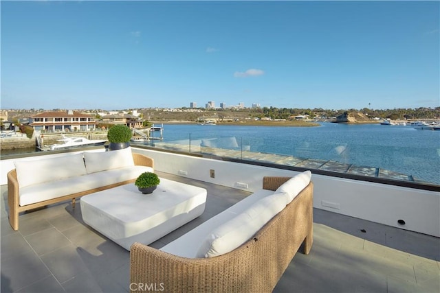 view of patio featuring a balcony and a water view