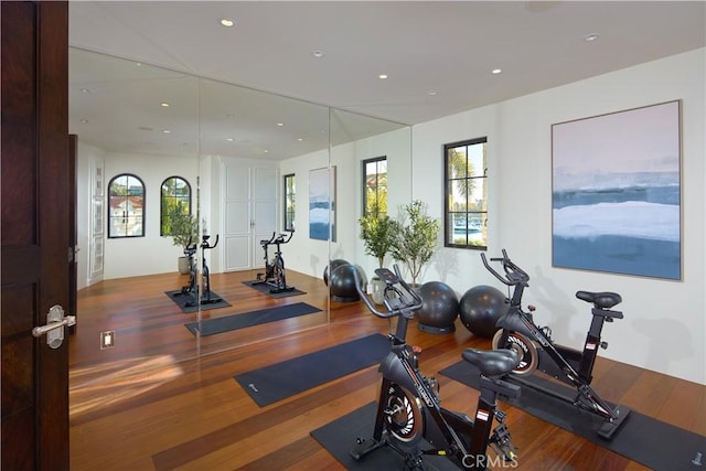 exercise room with a wealth of natural light, wood finished floors, and recessed lighting