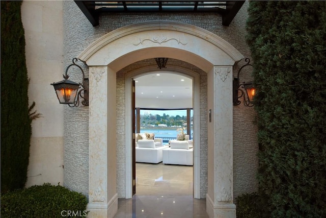 doorway to property featuring brick siding