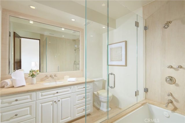 bathroom featuring enclosed tub / shower combo, recessed lighting, toilet, and vanity