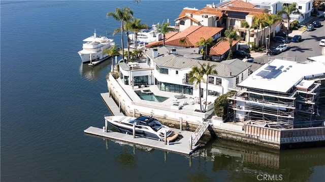 drone / aerial view featuring a residential view and a water view