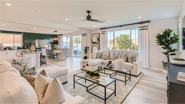 living room with light wood-style flooring and recessed lighting