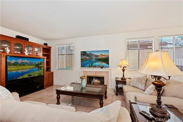 living area with light tile patterned floors and a tiled fireplace