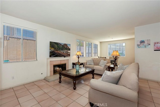 living area featuring light tile patterned floors and a fireplace