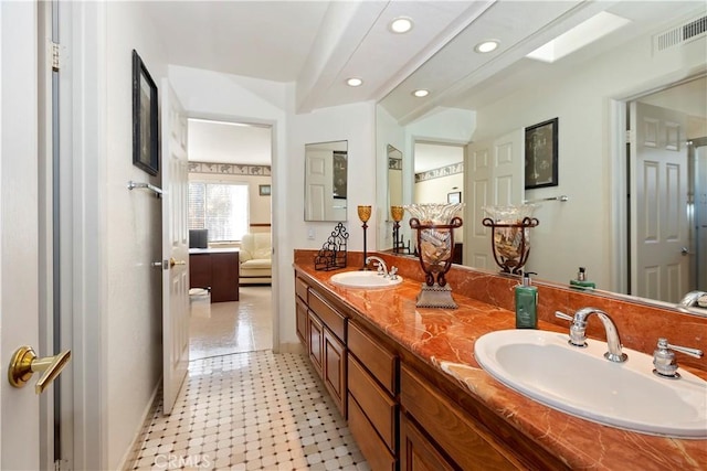 bathroom featuring ensuite bathroom, a sink, visible vents, and recessed lighting