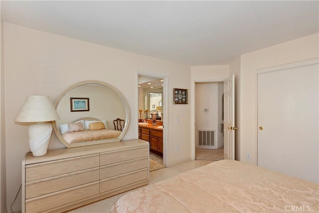 bedroom featuring visible vents, connected bathroom, and light carpet