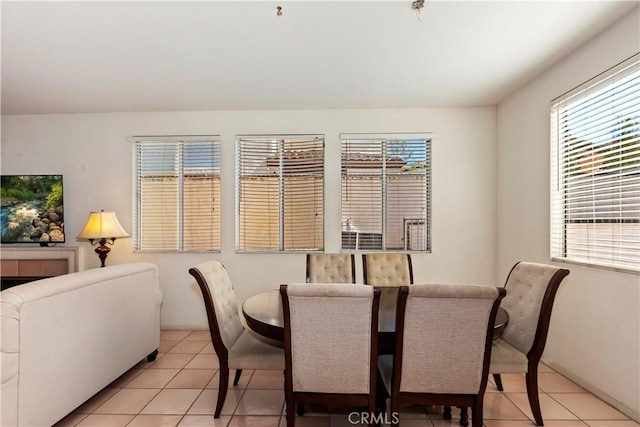 dining space with light tile patterned floors and a healthy amount of sunlight