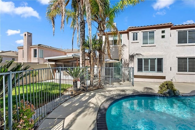 view of swimming pool featuring a fenced in pool, fence, and a patio