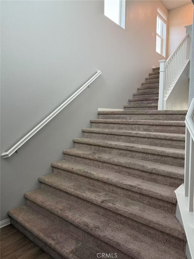 stairs featuring wood finished floors