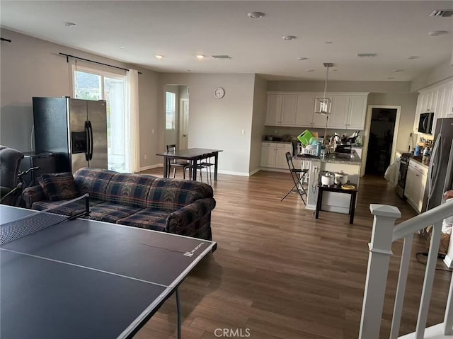 playroom featuring recessed lighting, visible vents, dark wood finished floors, and baseboards