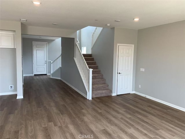 interior space featuring visible vents, stairway, baseboards, and wood finished floors