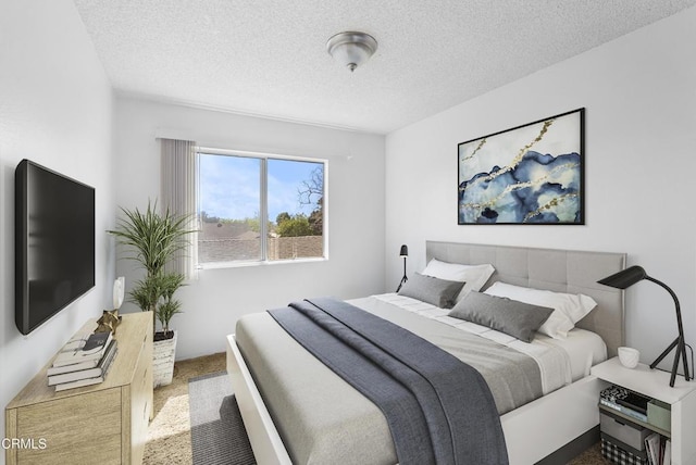 carpeted bedroom with a textured ceiling