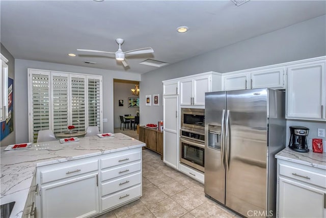 kitchen featuring light tile patterned floors, a ceiling fan, stainless steel appliances, white cabinetry, and recessed lighting