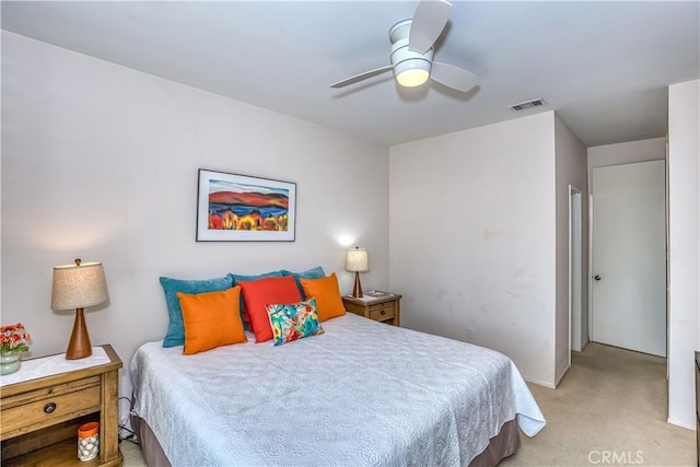 bedroom featuring light carpet, ceiling fan, and visible vents