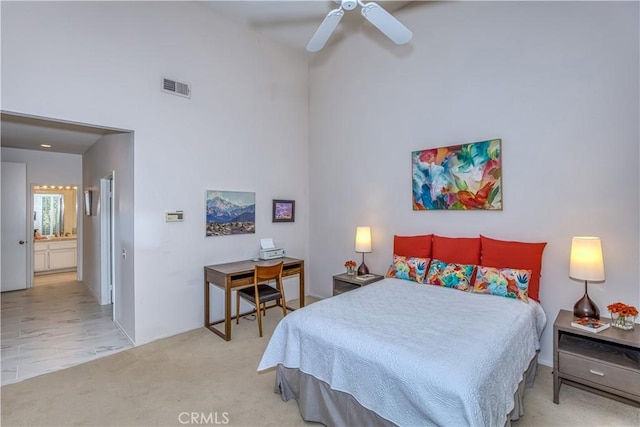 bedroom featuring carpet, visible vents, a high ceiling, a ceiling fan, and connected bathroom